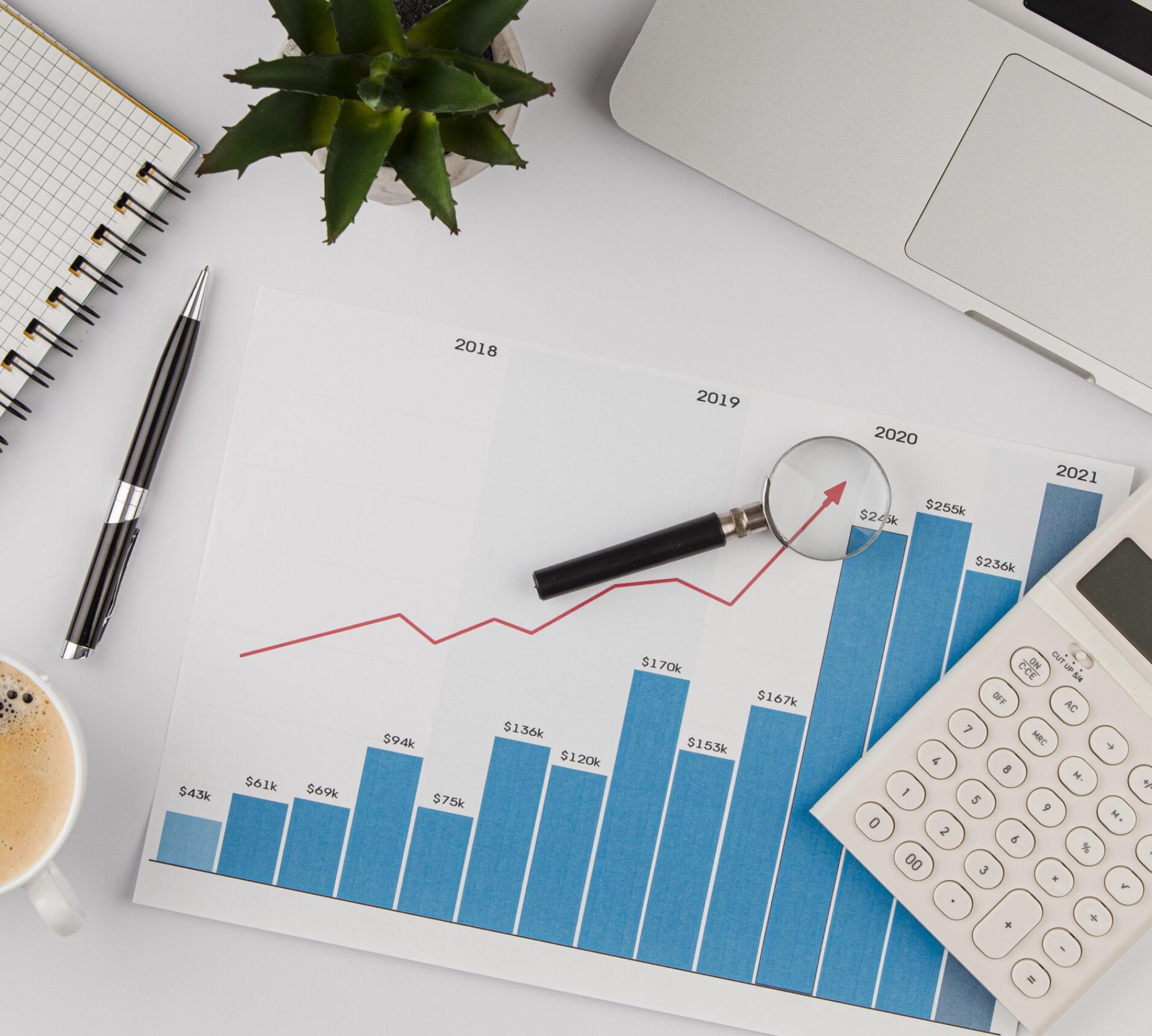 top-view-of-office-desk-with-growth-chart-and-calculator